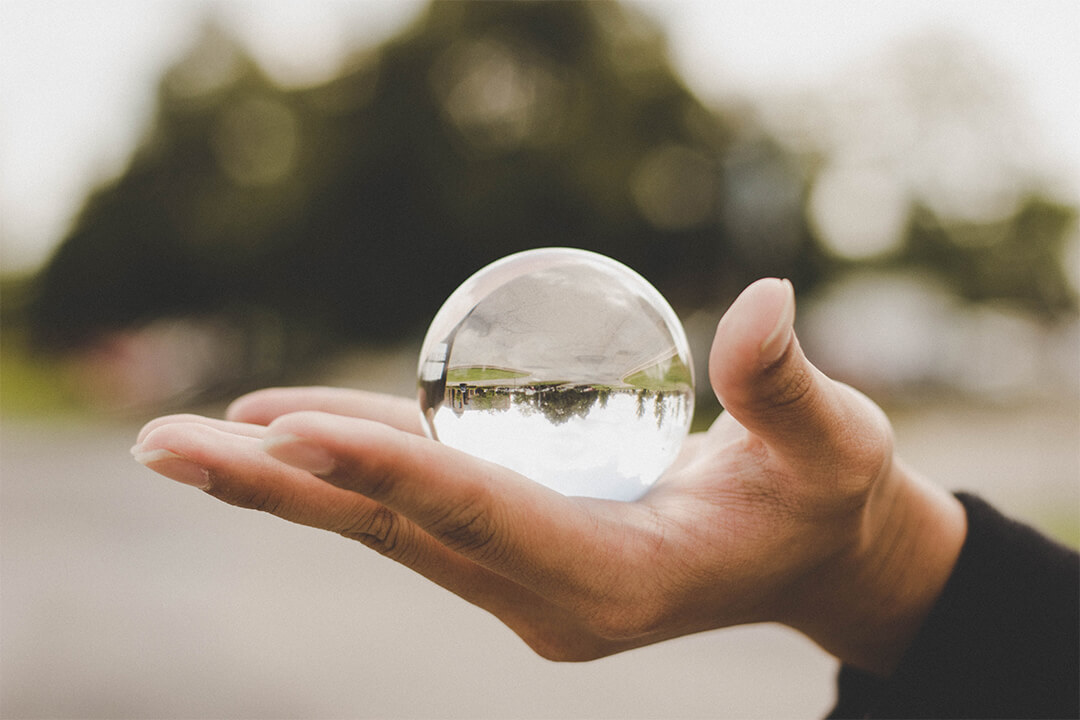 Hand holding crystal ball