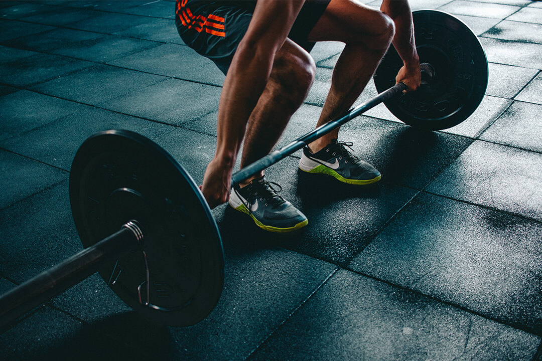 Person lifting weights from floor